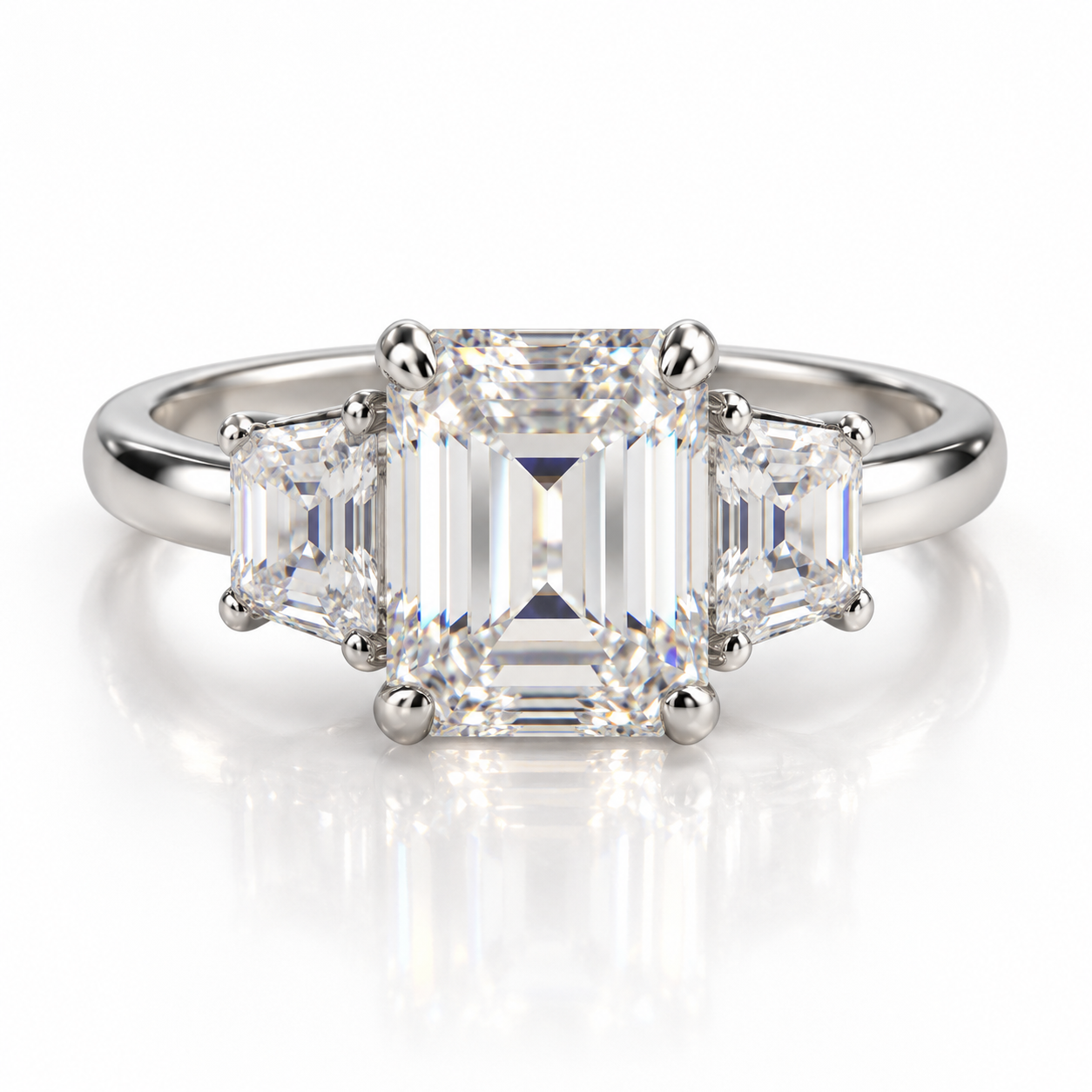 750/- White Band, White Setting Lab Grown Emerald Cut Centre With Step-Cut Trapezoid Each Side 3 Pcs Tdw: 5.00Ct Centre Emerald 4.00Ct 2 * Side Trapezoid Tdw: 1.00Ct E VVS